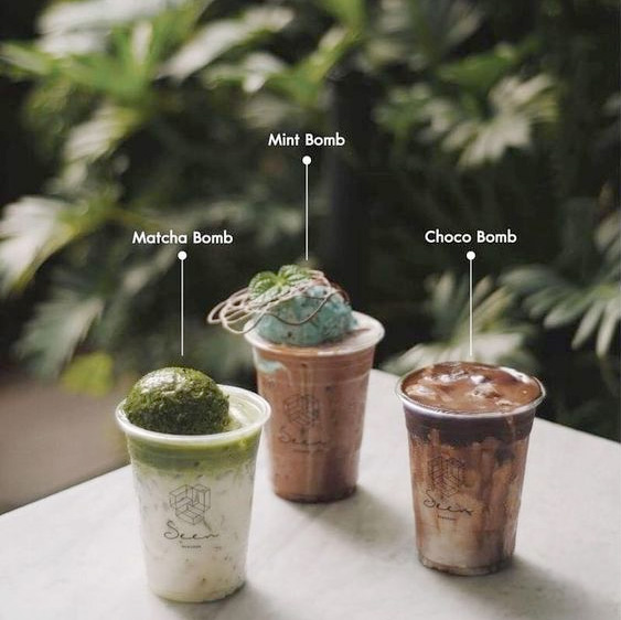 Three coffee drinks with the labels, Matcha bomb, Mint bomb and Choco bomb